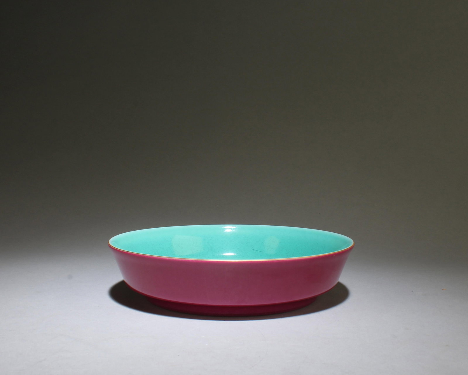 A Rogue-Red Glazed Plate: A Rogue-Red Glazed Plate, "YongZheng" mark at base. Dimensions: 6" x 1.4"
