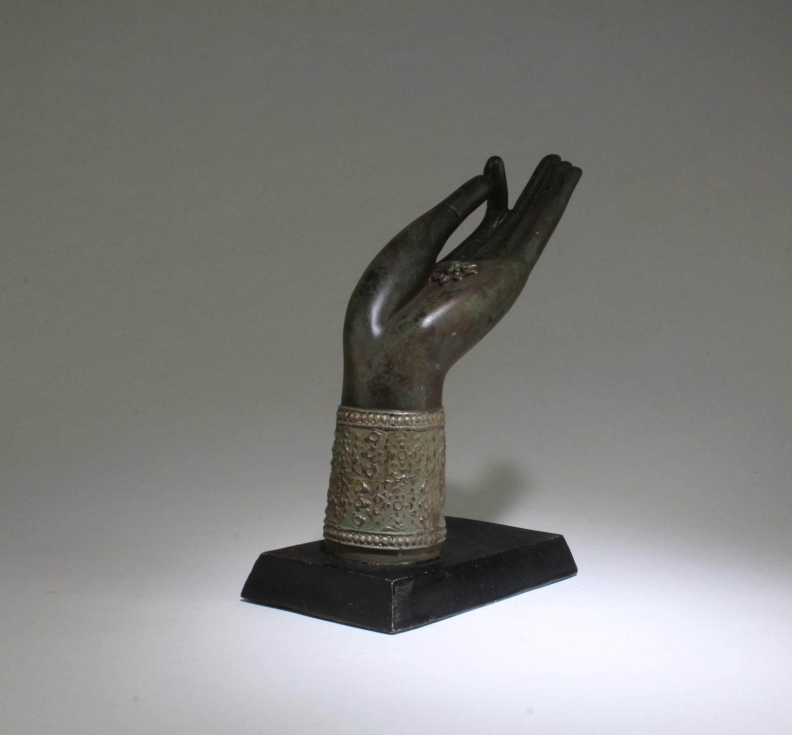 A Hand Figurine: A Hand Figurine. Comes fitted with a wooden stand. Height: 9.1" Length: 8" Width: 3.5"