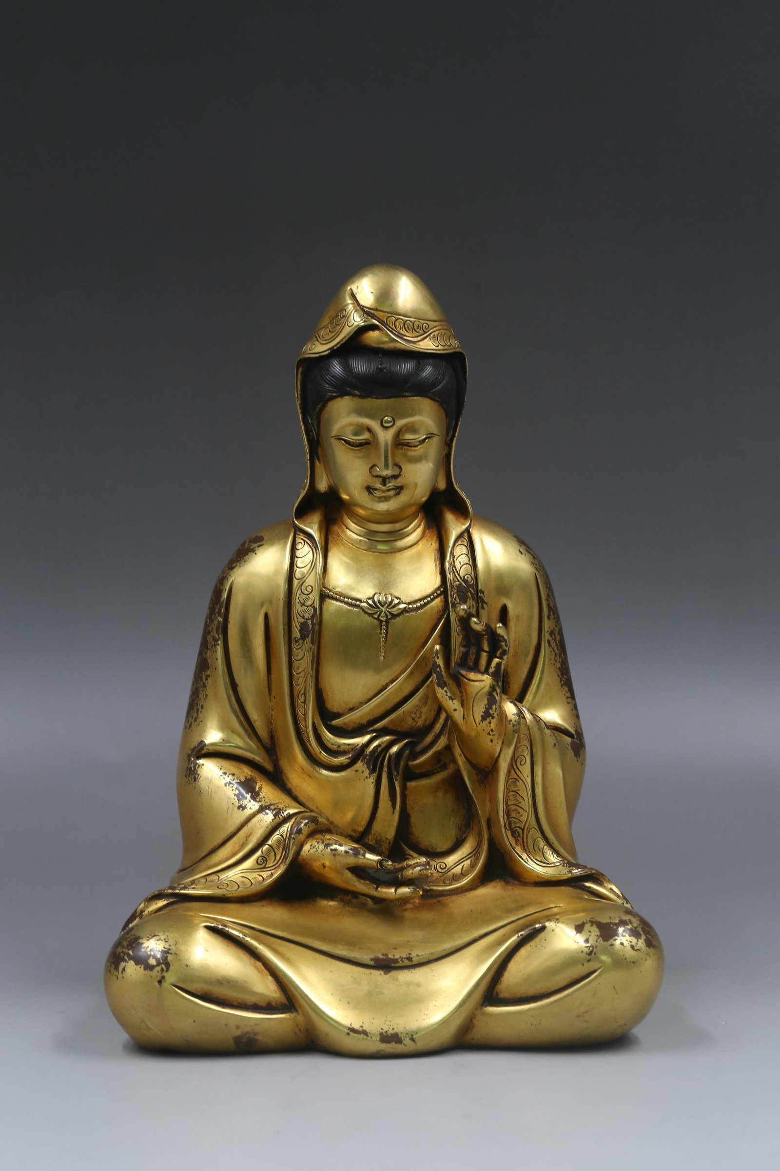 A Gilt Bronze Sitting Guan Yin Statue: A Gilt Bronze Sitting Guan Yin Statue. Dimensions: 11.81in x 5.91in x 8.27in. Weight: 9.26lb.