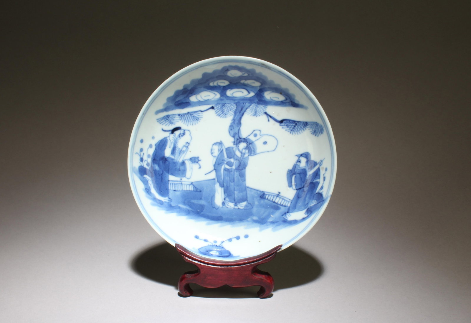 Antique Blue & White Porcelain Plate: Antique Blue & White Porcelain Plate. Seal mark at base. Comes with a wooden base. Diameter: 5.5"Provenance: Pasadena Antique Center