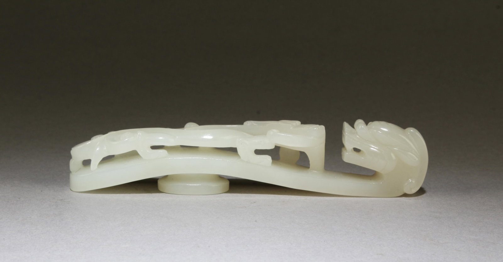 Chinese Jade Belt Buckle: Chinese Jade Belt Buckle. Comes fitted with a sooden stand. Length: 5.25"
