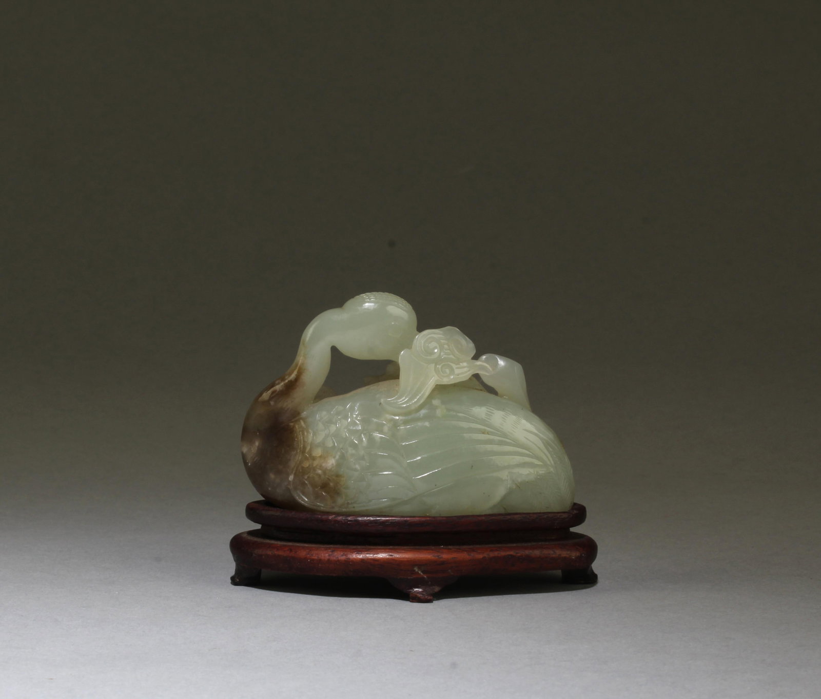 A Carved Jade Swan Figurine with Stand: A Carved Jade Swan Figurine with Stand. Length: 2.5"