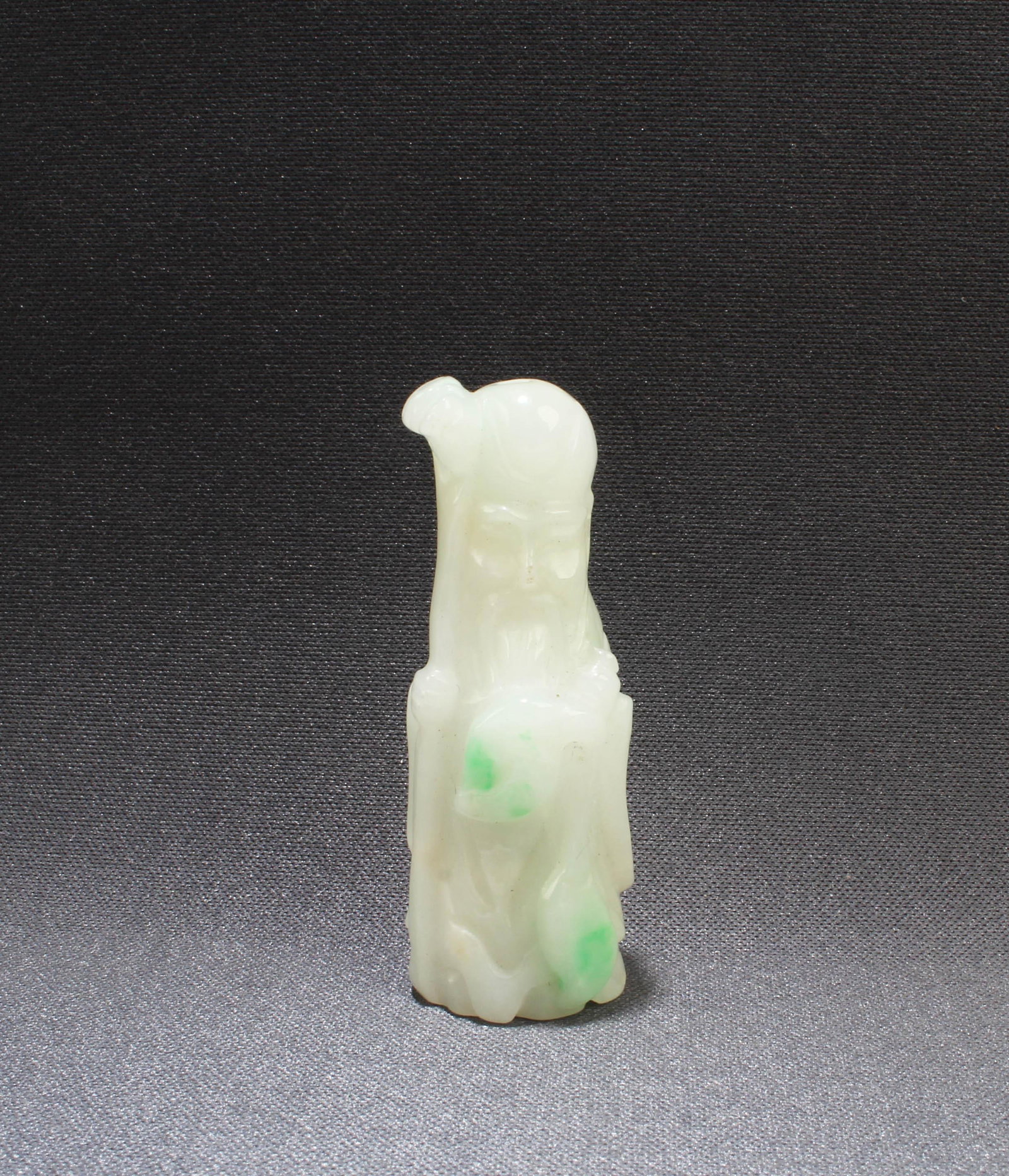 An Carved Jadeite Jade 'Shou Xing Gong' Figurine: An Unique Carved Jadeite Jade 'Shou Xing Gong' Figurine. Height: 1.75"