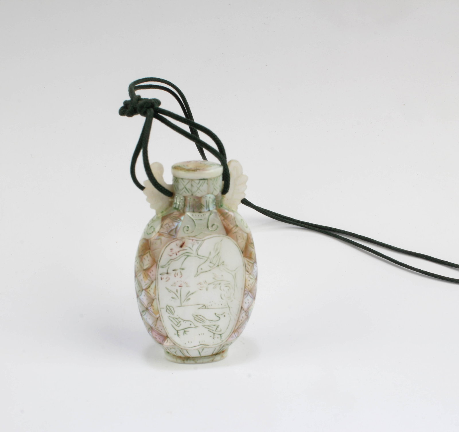 A Mother-of-Pearl Snuff Bottle: A Mother-of-Pearl Snuff Bottle, attached to a strine. Height: 1.9"