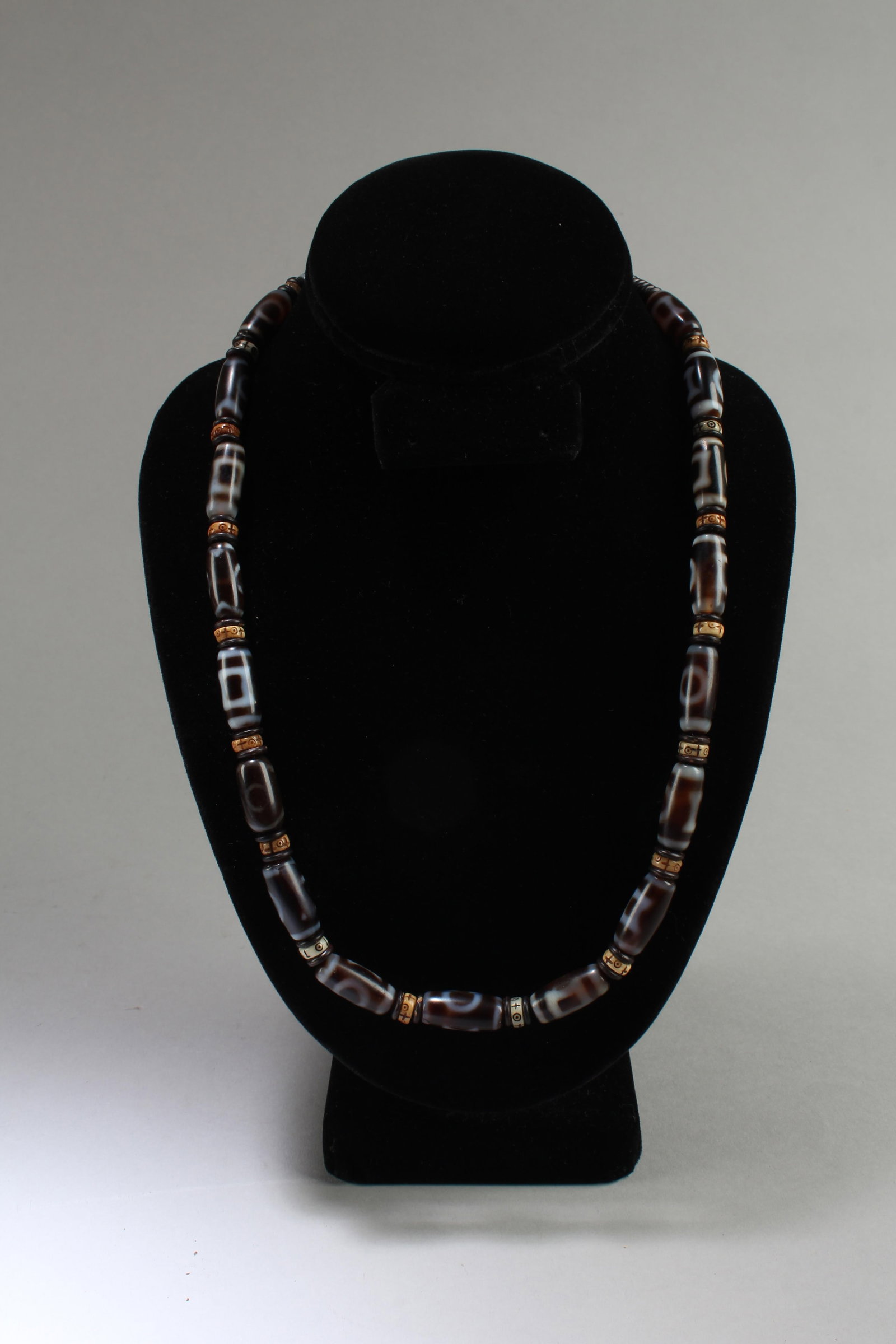 A Dzi Bead Necklace: A Dzi Bead Necklace. Length: 11.5"
