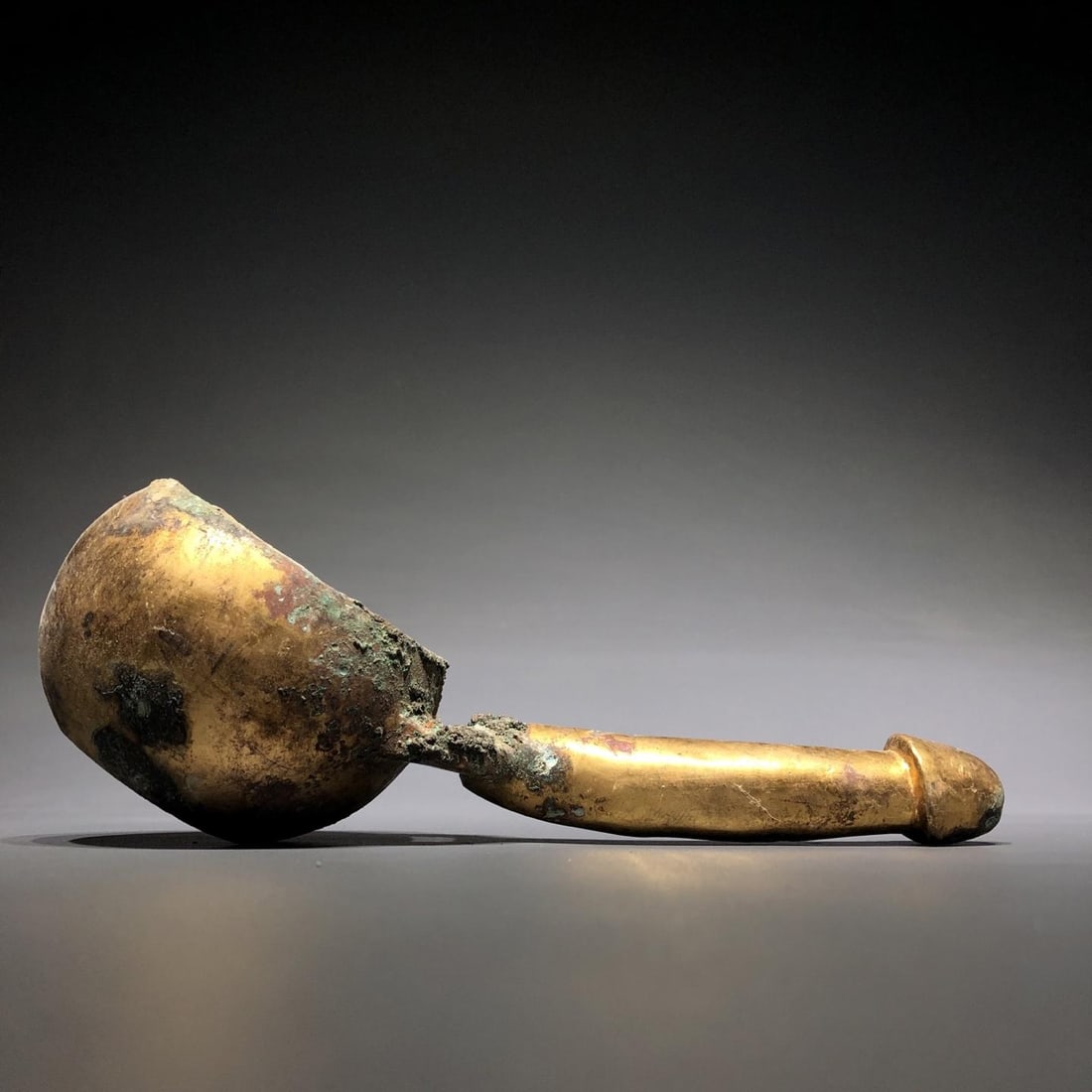 A Bronze Gilt Spoon: A Bronze Gilt Spoon. Dimensions: 7.87in x 2.76in x 314.96in Weight: 2.87lbs.