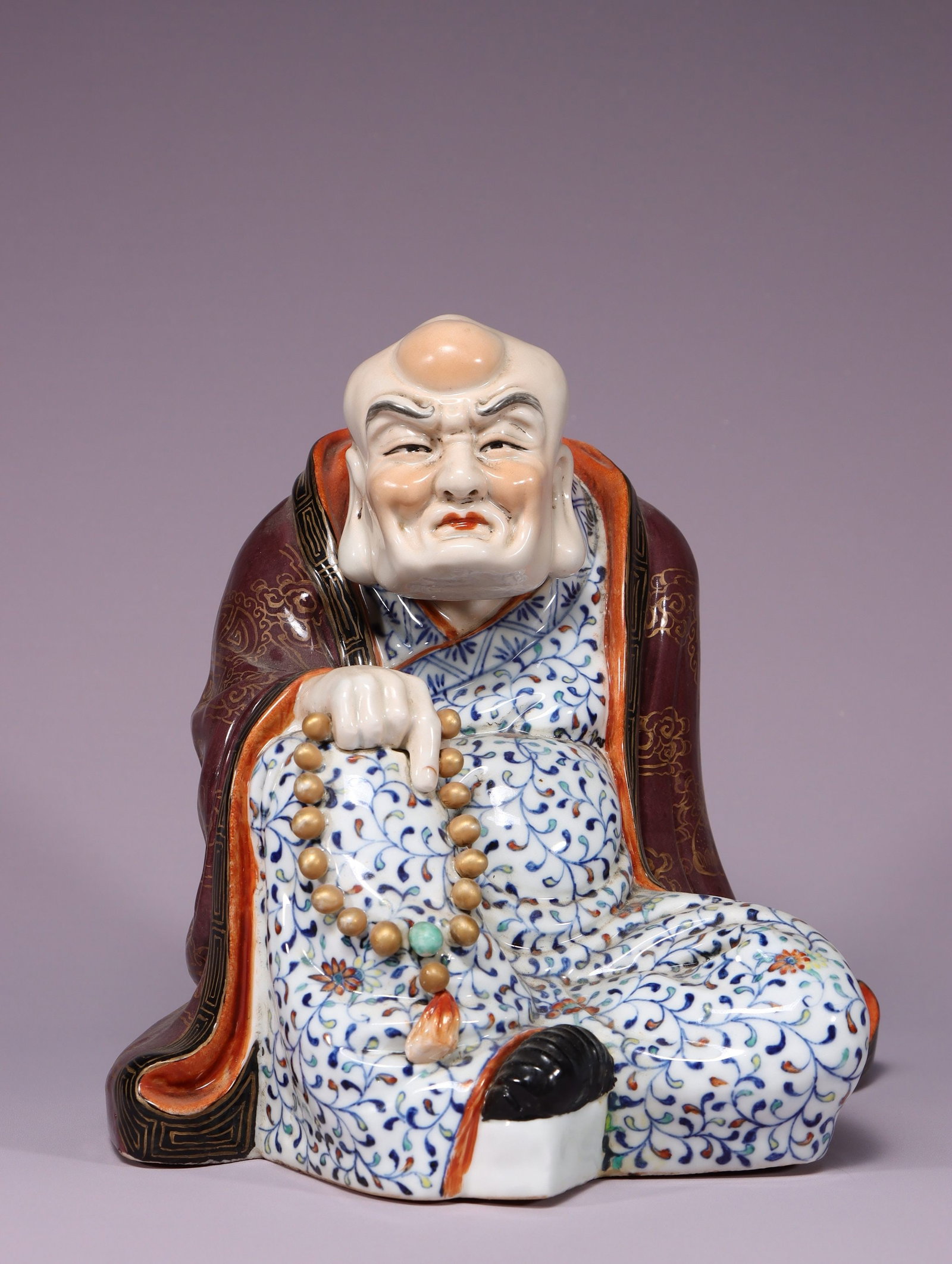 A Doucai Enamel Arhat Porcelain Figure: A Doucai Enamel Arhat Porcelain Figure. Dimensions: 8.66in x 9.06in x 7.09in Weight: 5.51lbs.