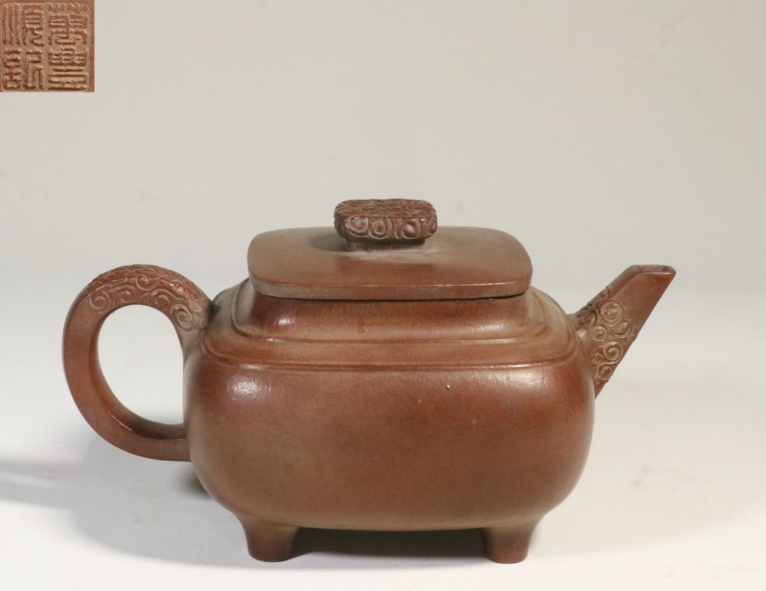 A Zisha Clay Four-Foot Cloud-Pattern Teapot: A Zisha Clay Four-Foot Cloud-Pattern Teapot. Height: 3.39in Length: 6.54in Diameter: 4.41in Weight: 0.68lbs.