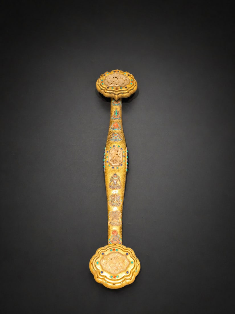 A Gold-Lacquer Ruyi Inlaid with Multiple Treasures and Eight Auspicious Symbols: A Gold-Lacquer Ruyi Inlaid with Multiple Treasures and Eight Auspicious Symbols. Length: 26.77in.