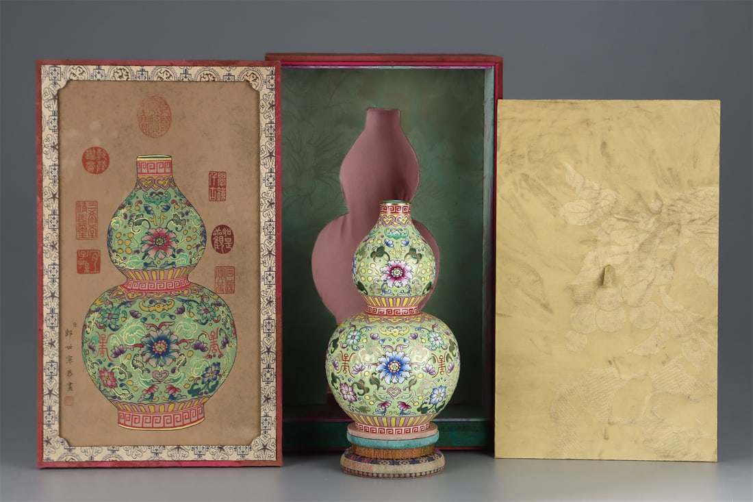 A Famille-Rose Gourd Vase with Floral Gold Decoration: A Famille-Rose Gourd Vase with Floral Gold Decoration. Height: 9.45in; Diameter: 5.71in.