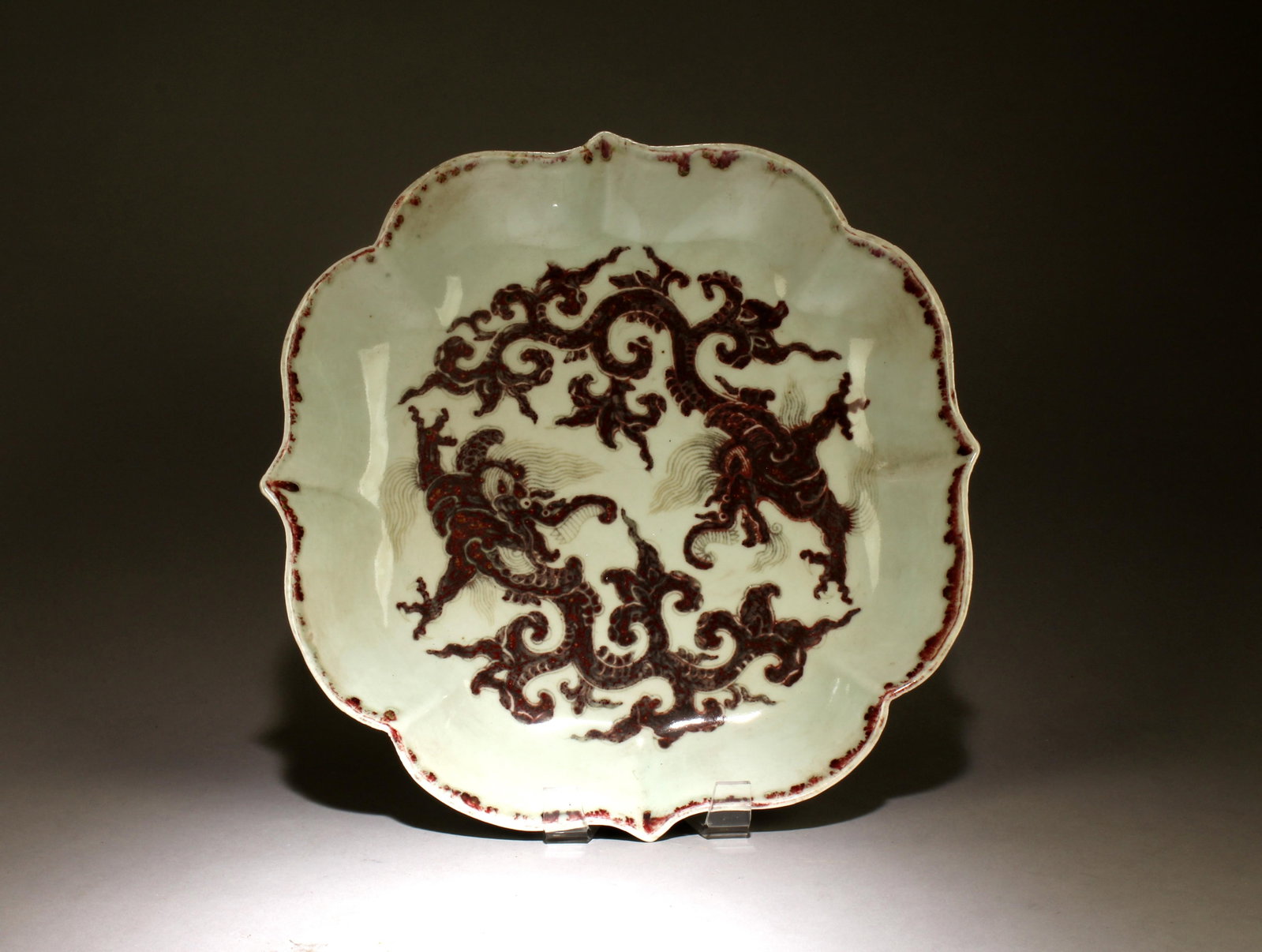 A Chinese Porcelain Plate with a Red Underglaze: A Chinese Porcelain Plate with a Red Underglaze Design . Dimensions: 13" x 2".