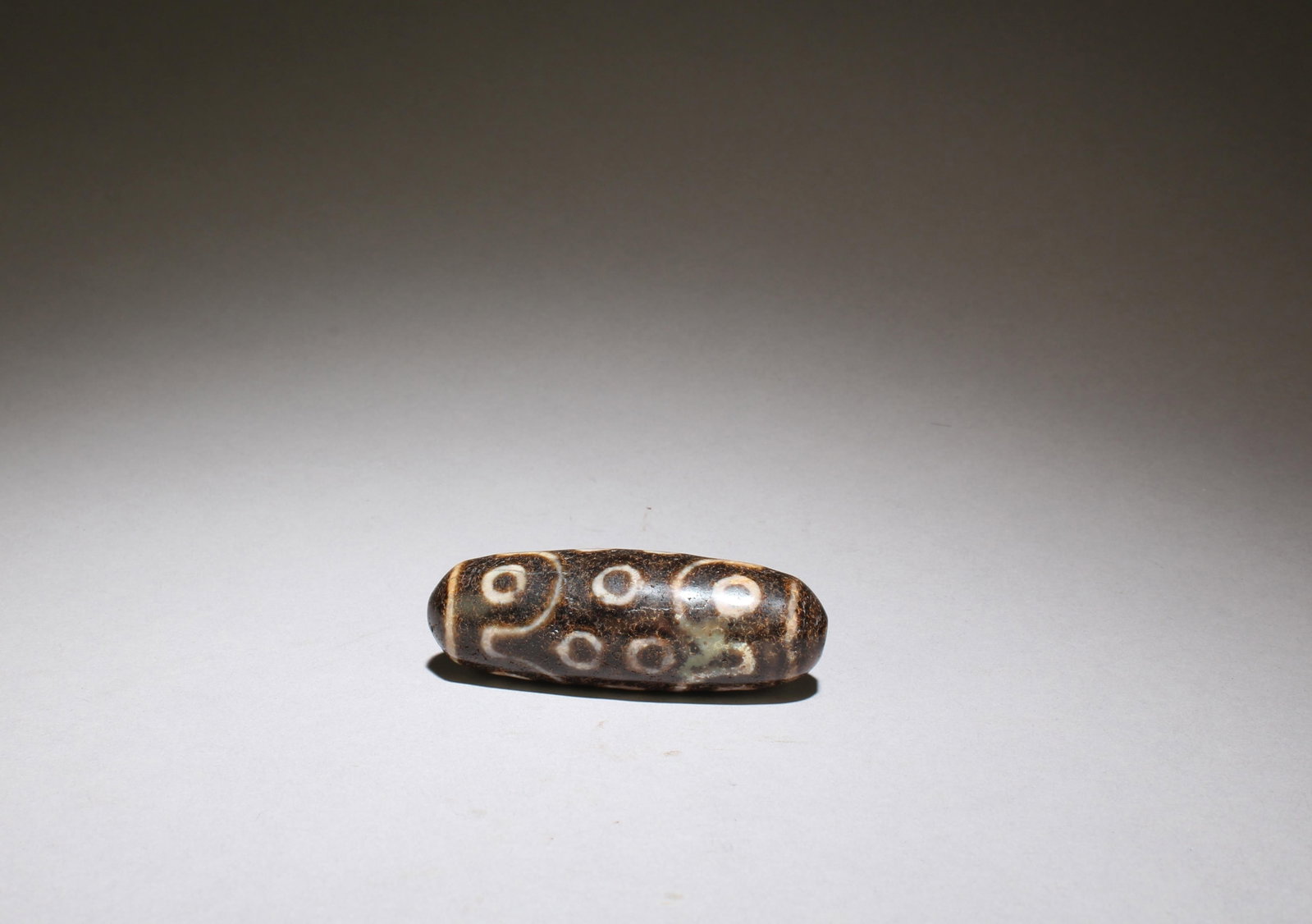 A Dzi Bead: A Dzi Bead. Length: 2.5"