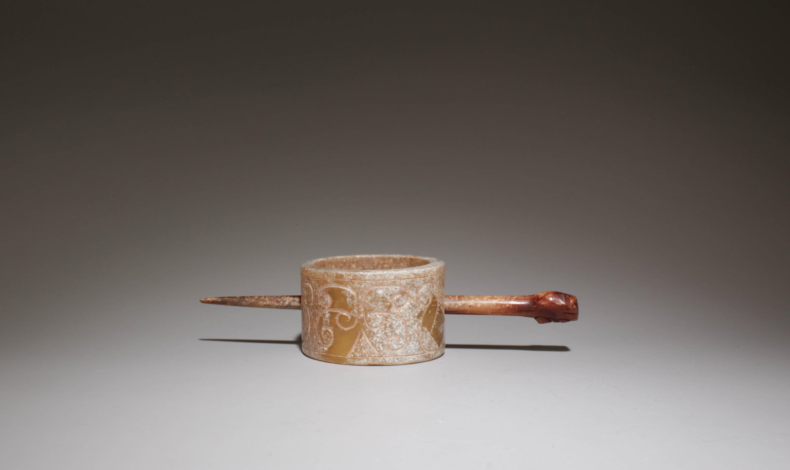 A Carved Jade Hairpin: A Carved Jade Hairpin. Diameter: 2.25". Length: 5.9".