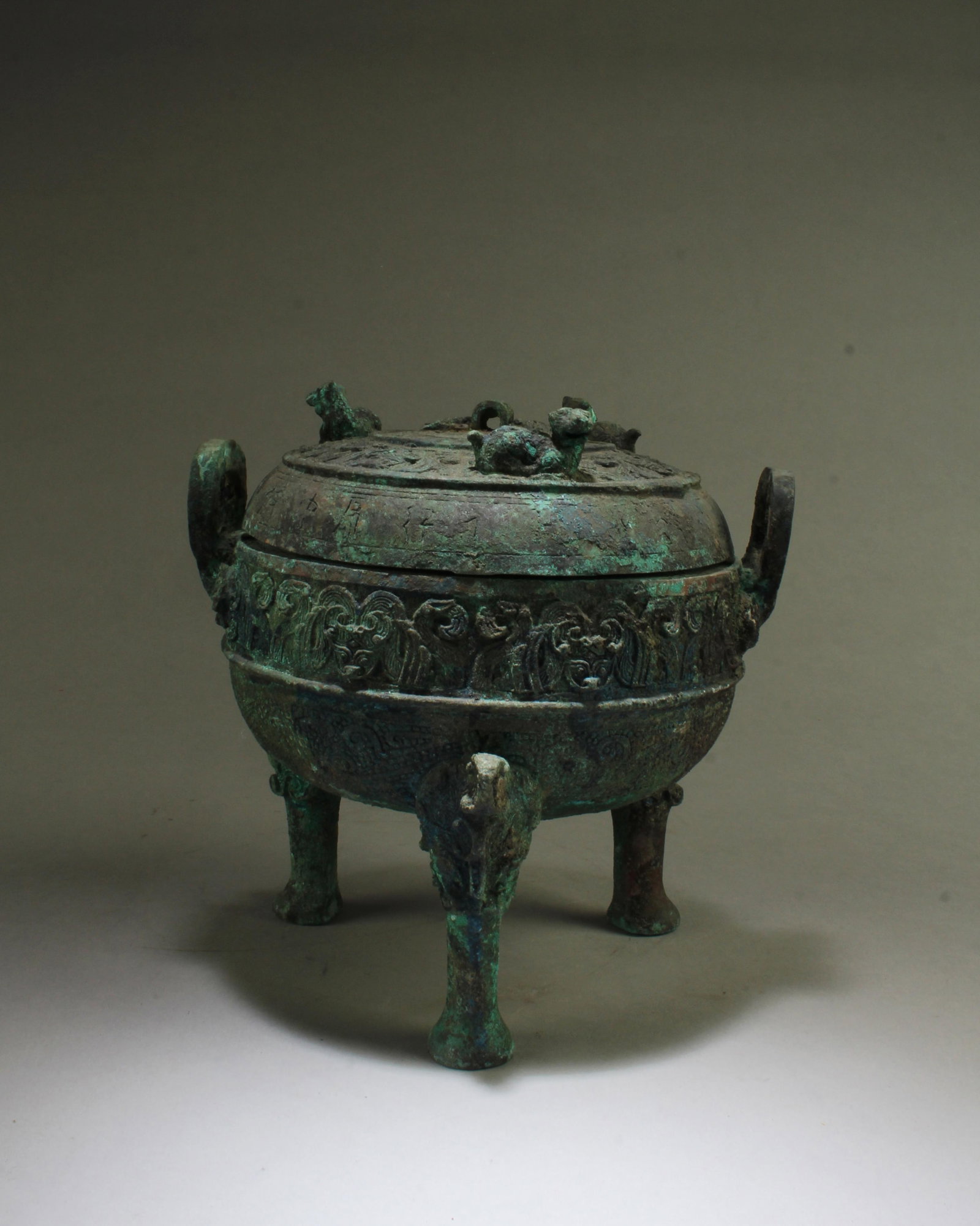 A Bronze Tripod Censer with Twin Handles: A Bronze Tripod Censer, flanked by Twin Handles, with lid. Height: 8"