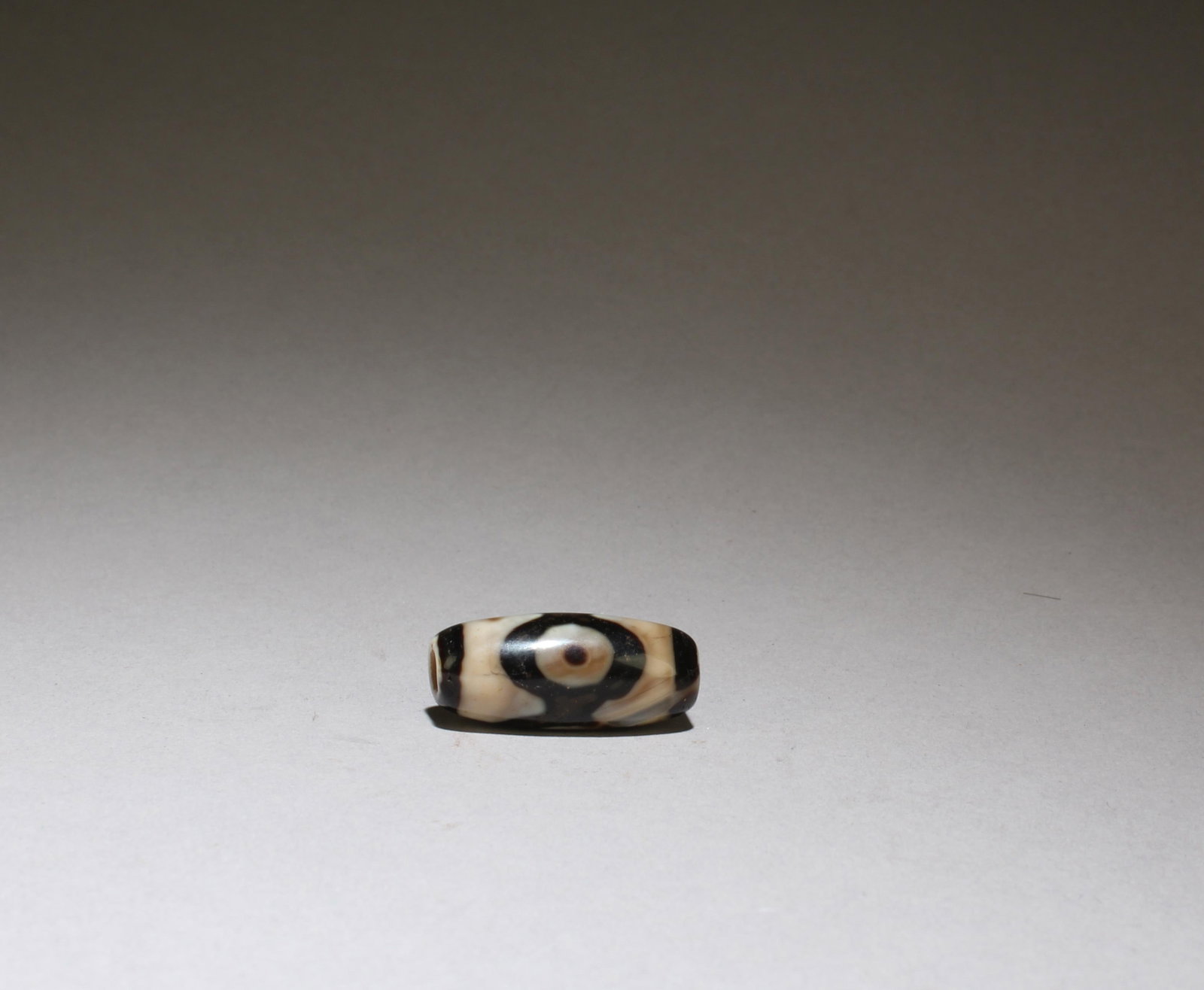 A Dzi Bead: A Dzi Bead. Length: 1"