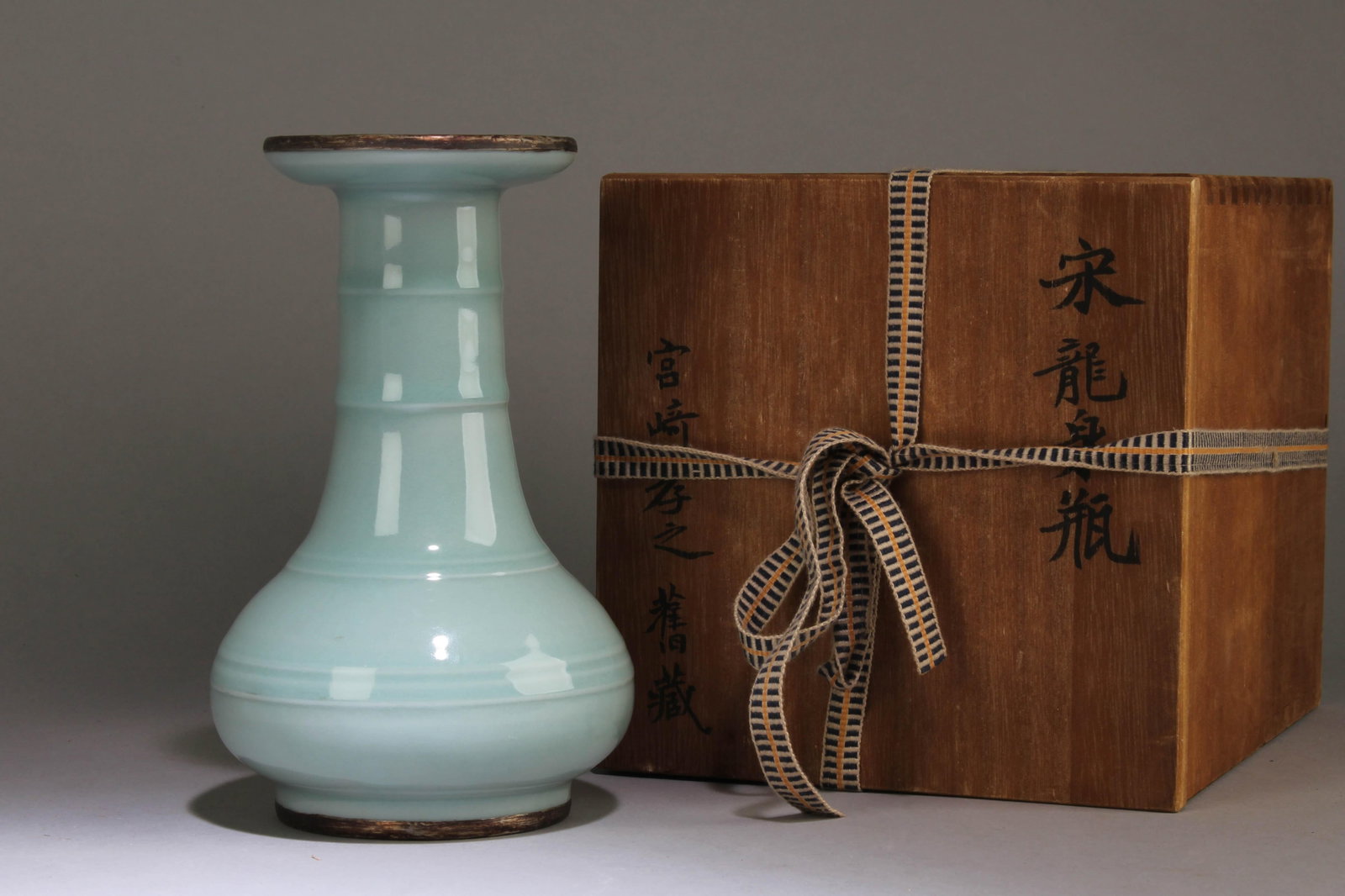 A Chinese Longquan Vase: A Chinese Longquan Vase with A Chinese Poem on the Bottom. Dimensions: 7.5" x 5".