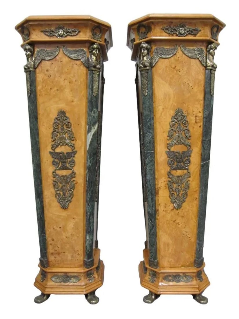 A Pair of Antique European Stands: A pair of european ornamental stands, marble sides and decorative metal corners featuring female faces with scrolled designs, plain hexagonal top and brass feet. Height: 52 "