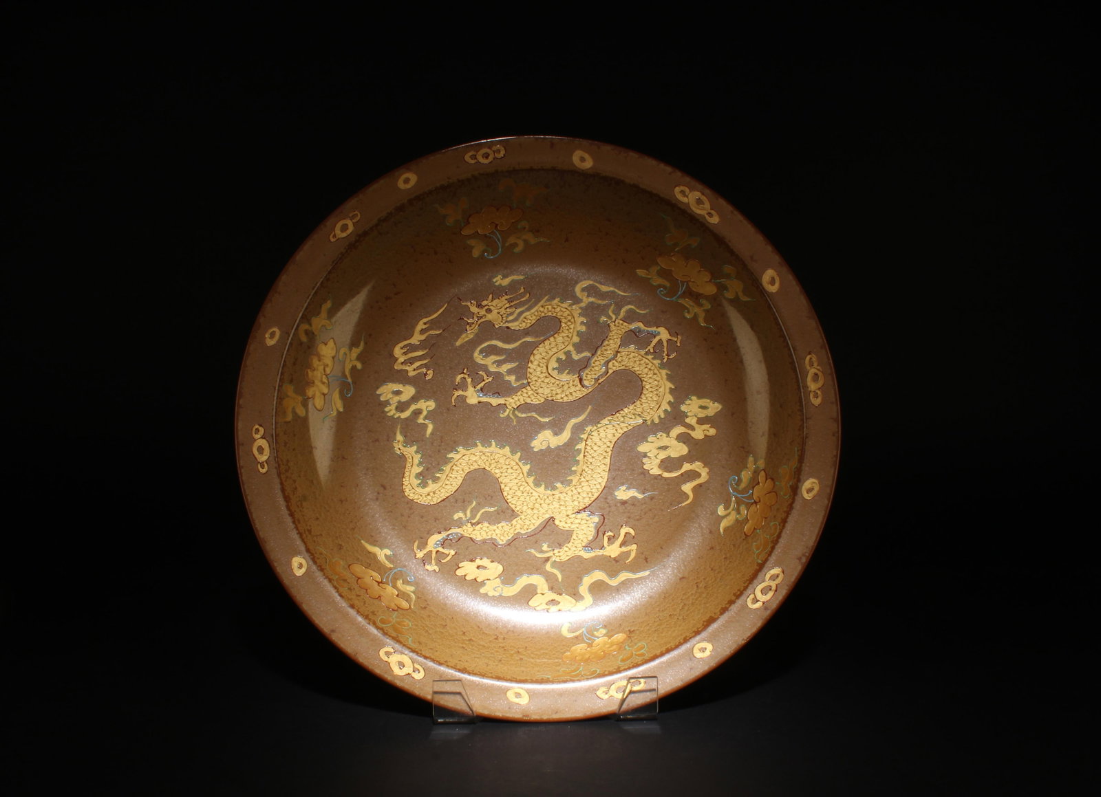 A Porcelain Charger: A Porcelain Charger, interior decorated with a golden dragon. Dimensions: 15.8" x 2.2".
