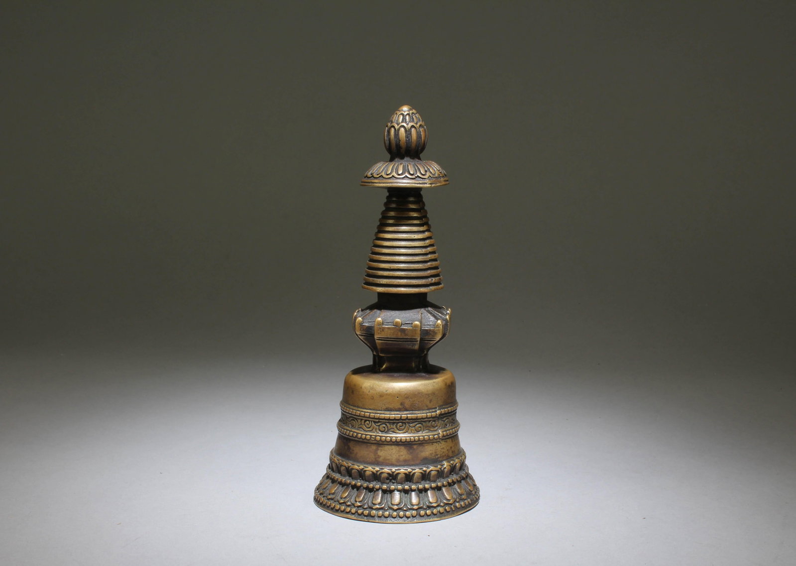 A Bronze Stupa: A Bronze Stupa. Dimensions: 7" x 3".