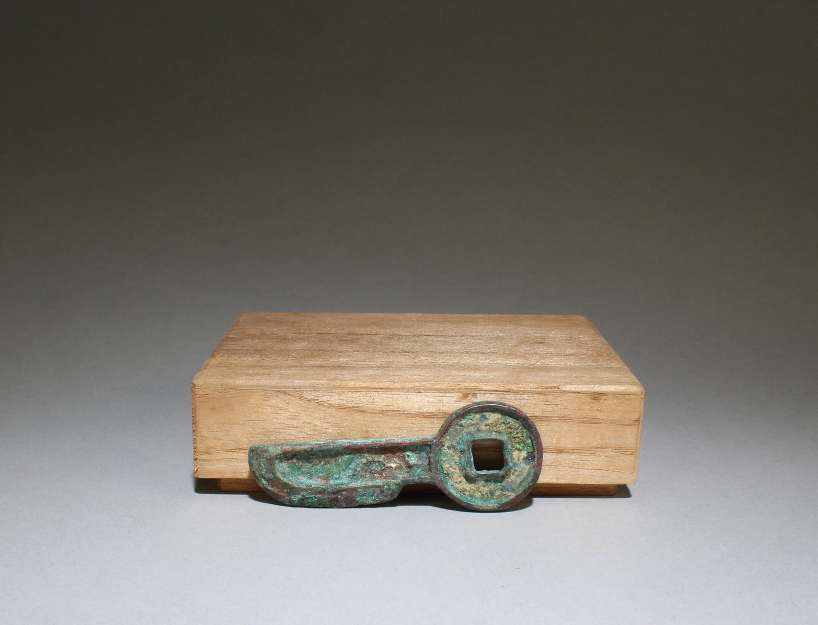 A Bronze Ornament with Box: A Bronze Ornament with Box. Dimensions: 2.75" x 1"