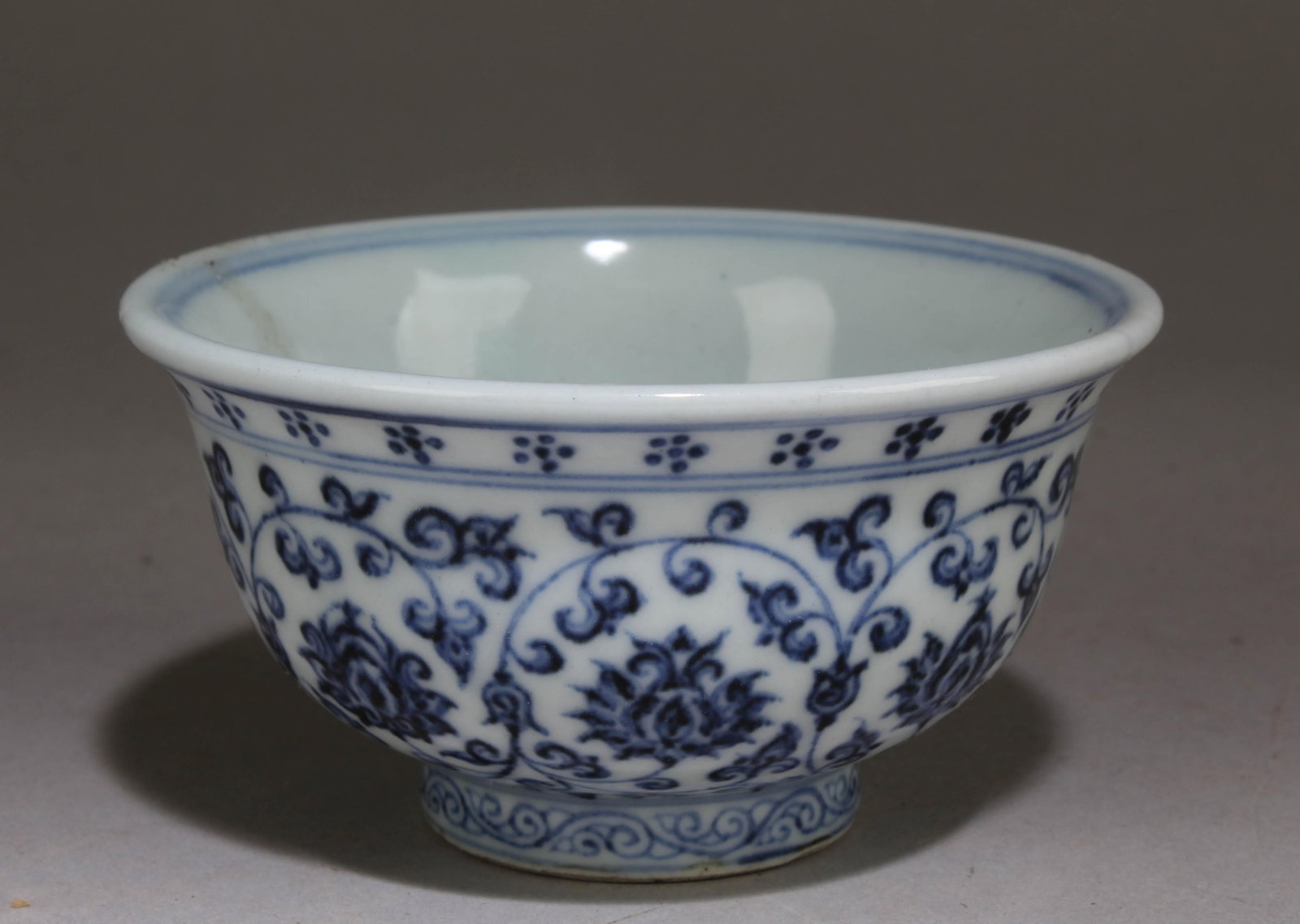 A Blue and White Chinese Cup with a Floral Pattern: A Blue and White Chinese Cup with a Floral Pattern. Dimension: 2.2" x 3.8".
