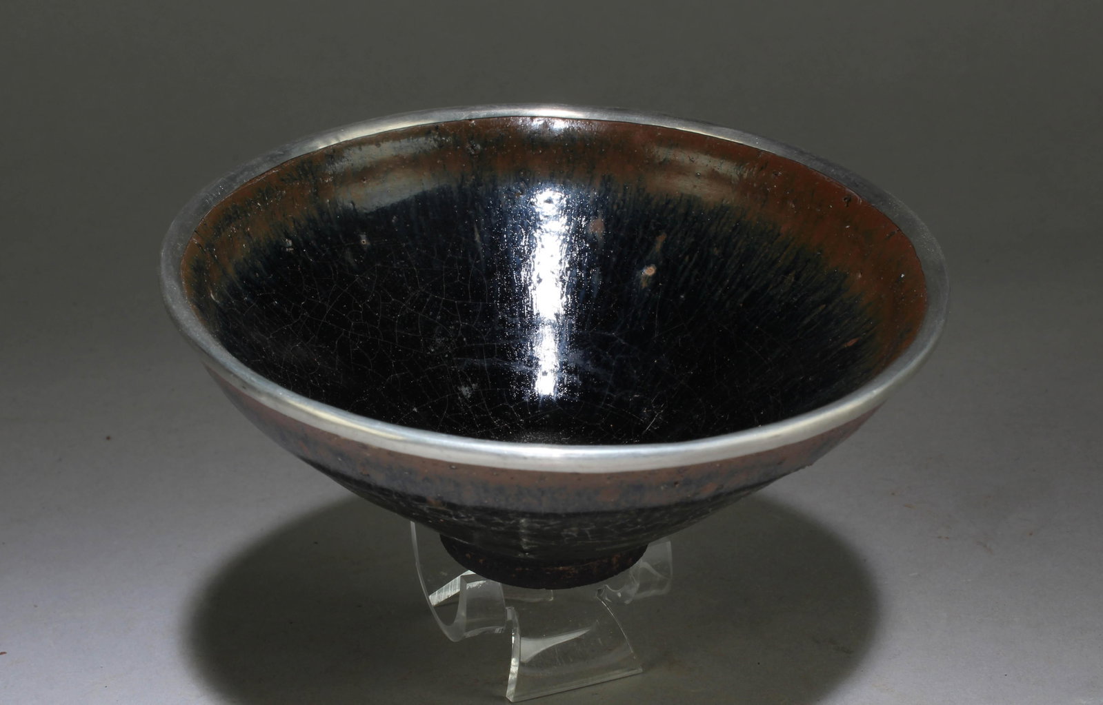 A Jianyao Bowl with a Silver Color Brim: A Jianyao Bowl with a Silver Color Brim. Dimension: 2.4" x 5.3".