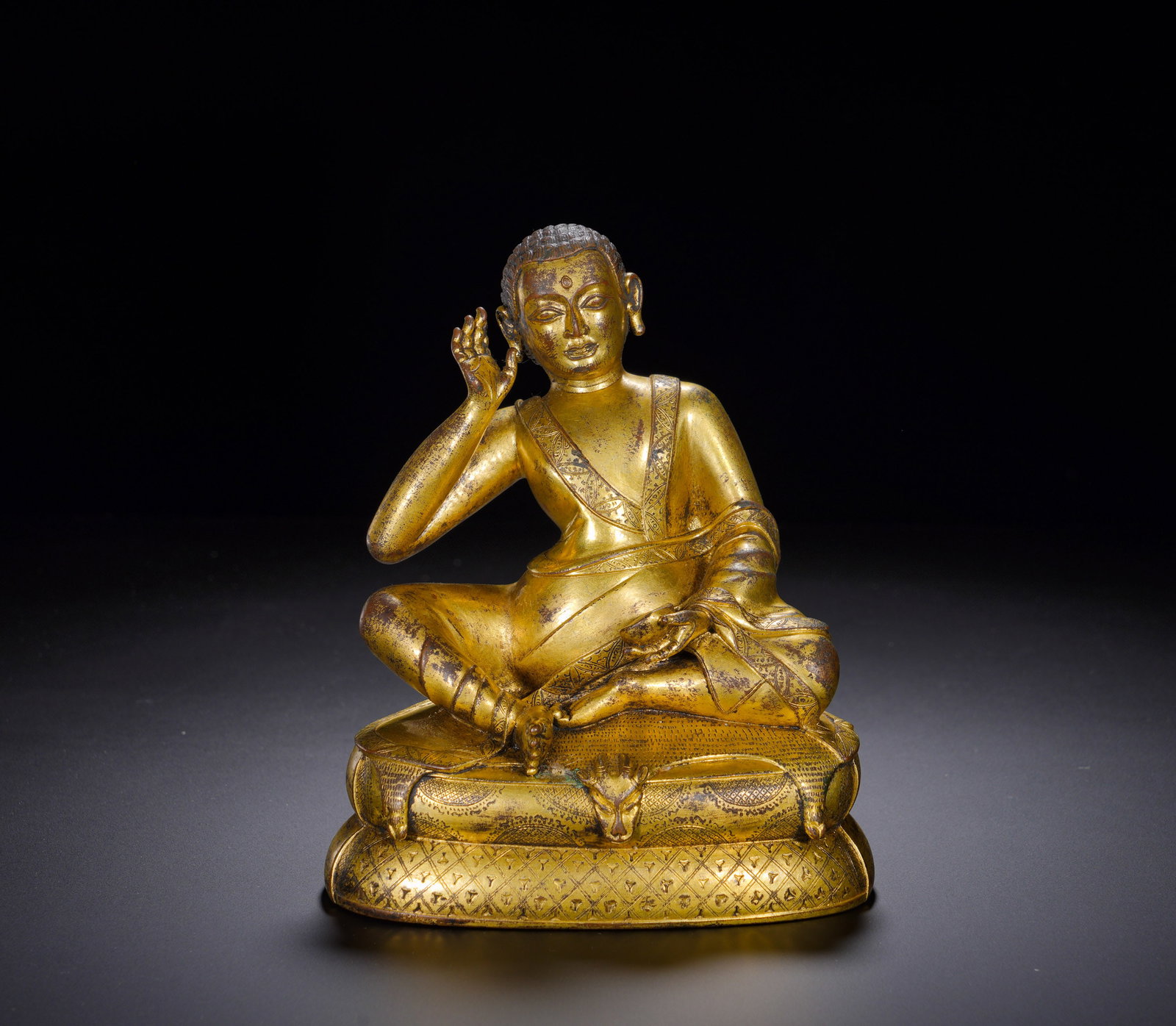 A GILDED BRONZE STATUE OF MILAREPA FROM THE MING DYNASTY: A GILDED BRONZE STATUE OF MILAREPA FROM THE MING DYNASTY. Height:17cm(6.69in), Width:14cm(5.51in), Weight:1670g (3.682lb)Cast bronze fully gilded, depicting Milarepa, the great master of the Tibetan K