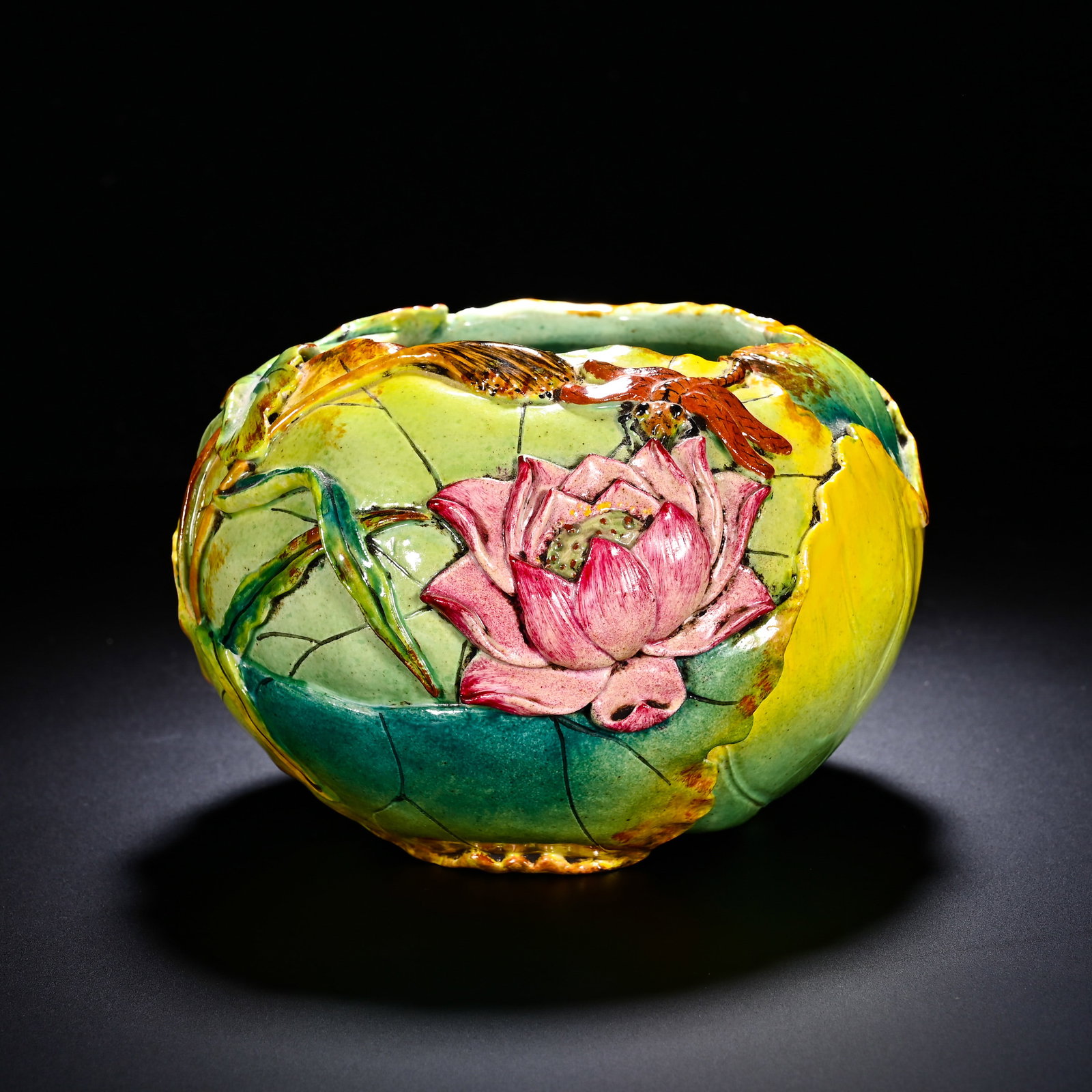 QING DYNASTY IMITATION PORCELAIN SCULPTURE OF A LOTUS POND WITH CLEAR WATER WASH: QING DYNASTY IMITATION PORCELAIN SCULPTURE OF A LOTUS POND WITH CLEAR WATER WASH. Height:8cm(3.15in), Diameter:13cm(5.12in)A scholar-studio water-washer modelled after curled-up lotus-leaf. High-relie