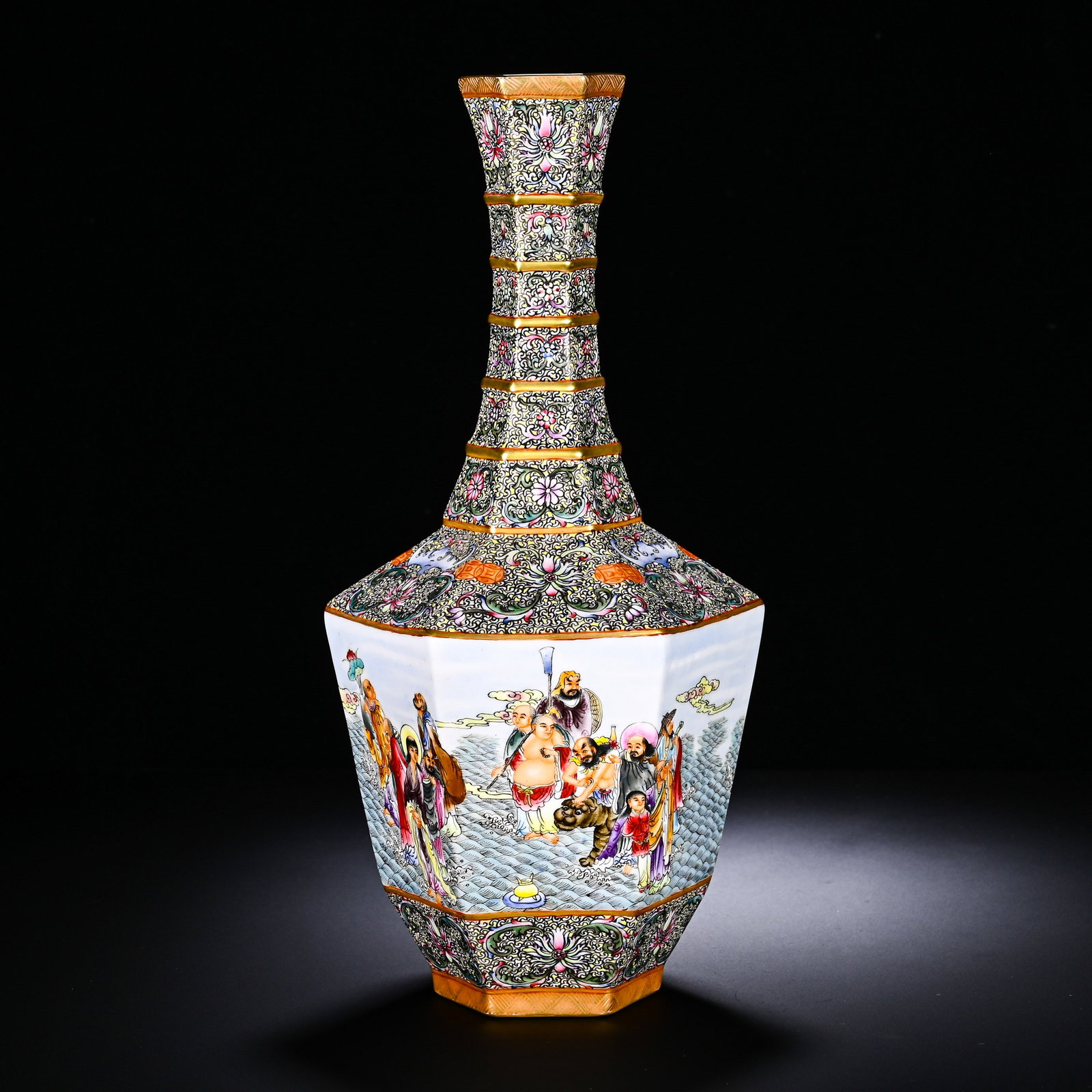 A LONG NECKED VASE WITH GILDED PATTERNS OF THE EIGHTEEN ARHATS CROSSING THE SEA: A LONG NECKED VASE WITH GILDED PATTERNS OF THE EIGHTEEN ARHATS CROSSING THE SEA. Height:31cm(12.20in), Diameter:14cm(5.51in)This is a Qianlong-period hexagonal long-neck vase with famille-rose and gil