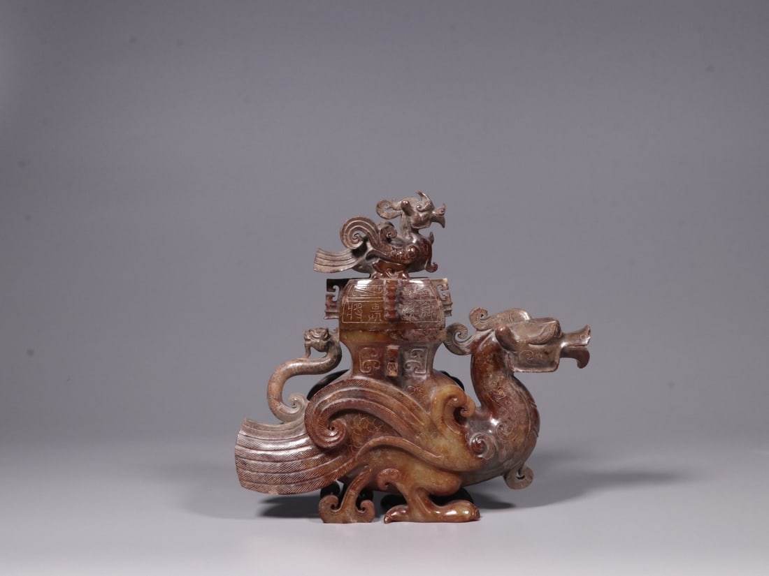 A Jade Bird Figurine: A Jade Bird Figurine. Dimensions: 7.48in x 7.87in x 2.36in; Weight: 3.69lbs.