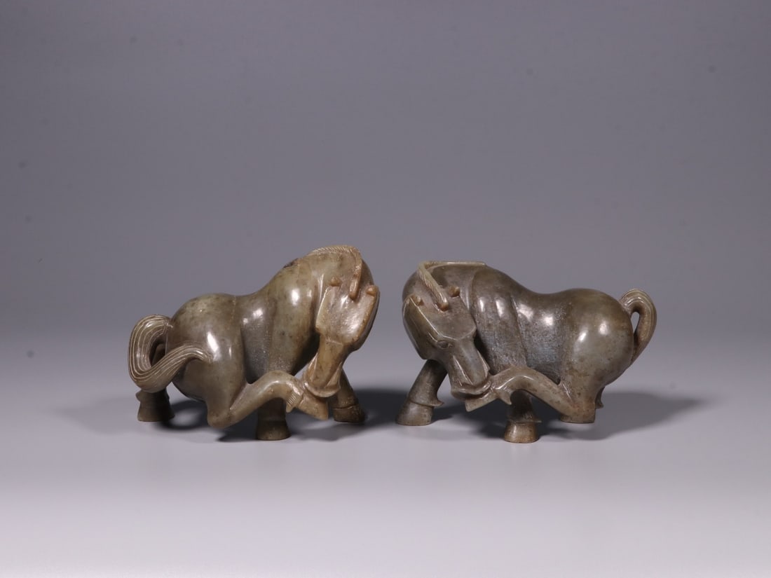 A Pair of Hetian Jade Horse Figurines: A Pair of Hetian Jade Horse Figurines. Dimensions: 3.94in x 5.51in x 2.76in; Weight: 2.02lbs / 2.04lbs.