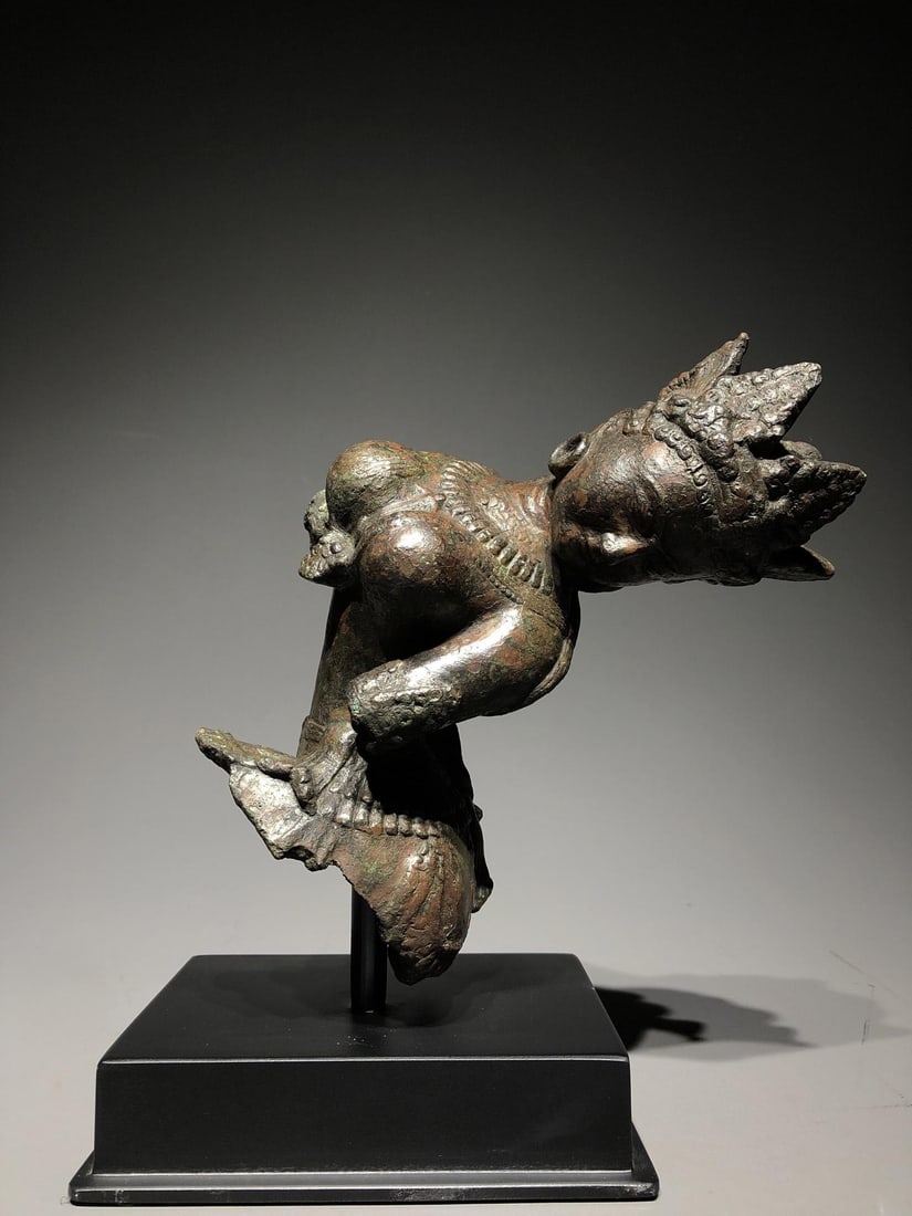 A Bronze Figurine: A Bronze Figurine. Diameter: 4.33in; Width: 3.54in; Height: 8.66in; Weight: 13.23lbs; Total Height: 10.63in.