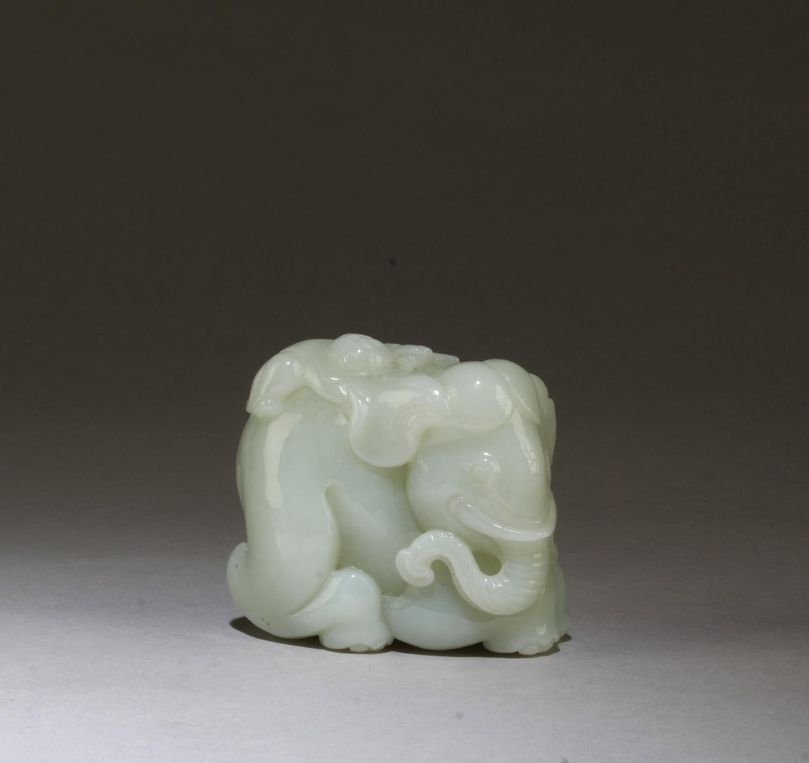 Chinese Hetian Jade Ornament: Intricately carved Elephant Hetian Jade ornament. Length: 2.75"