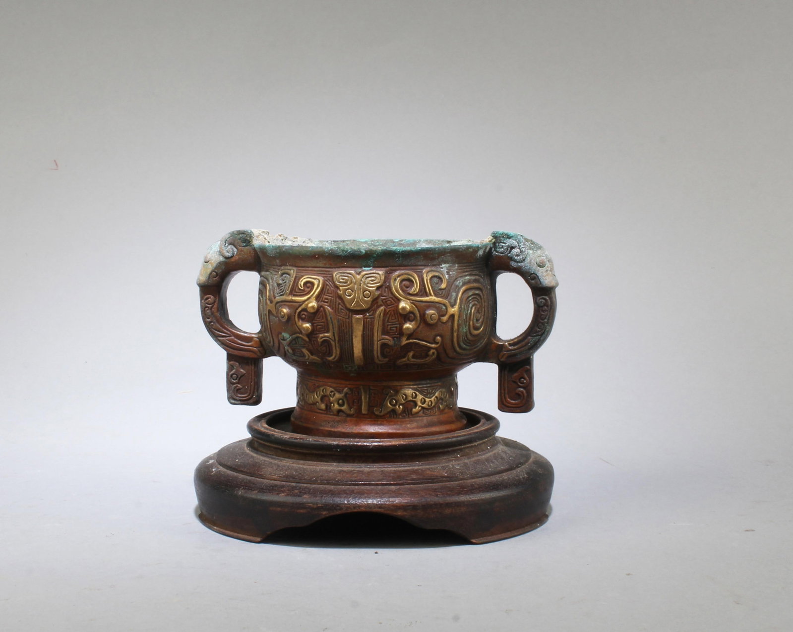 A Bronze Incense Burner: A Bronze Incense Burner. comes fitted with a wooden base. Length: 4.5" Height: 2.2"Provenance: From Pasadena Antique Centre
