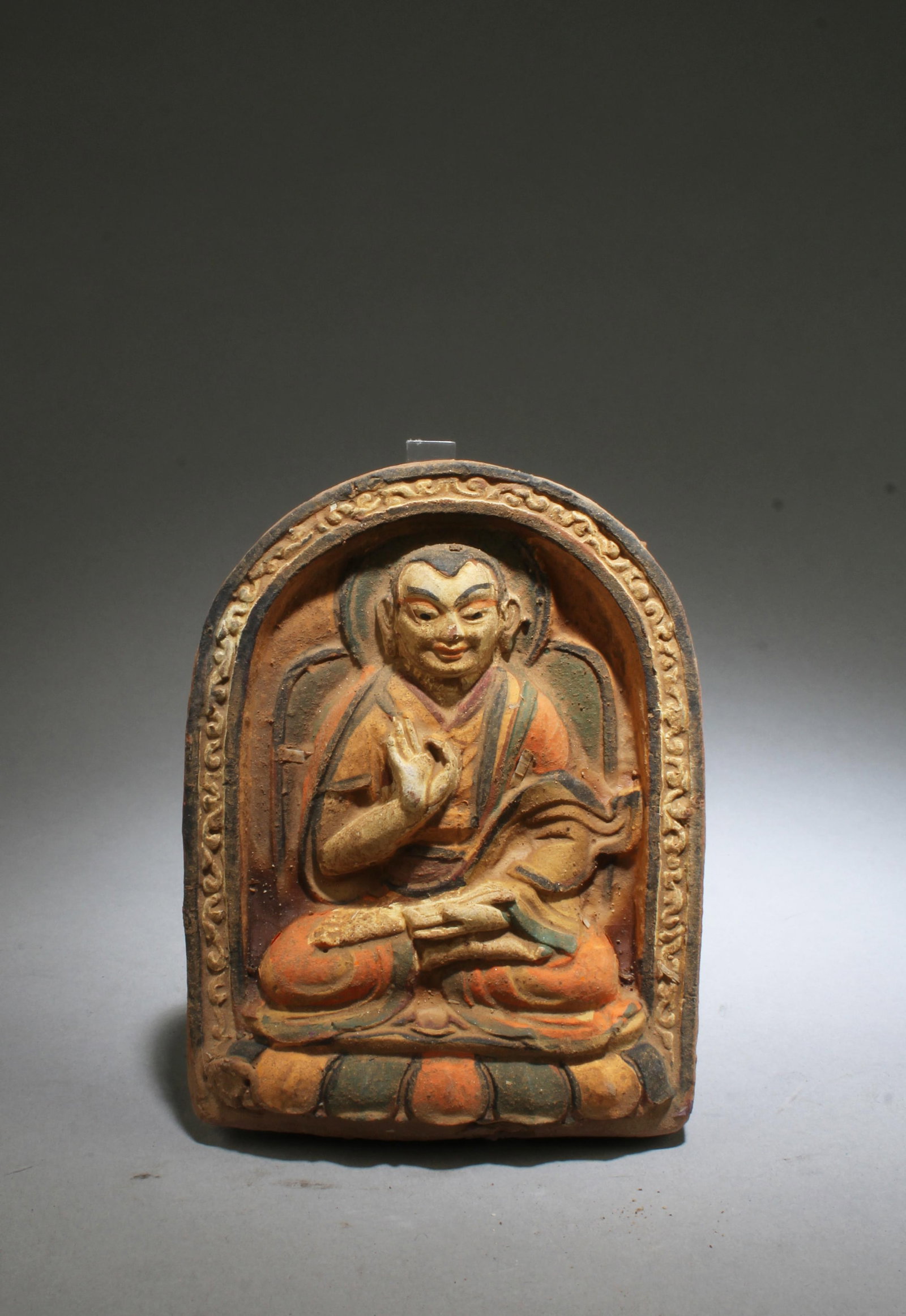 A Clay Buddha Statue: A Clay Buddha Statue. Height: 4.75" Length: 4" Width: 1"