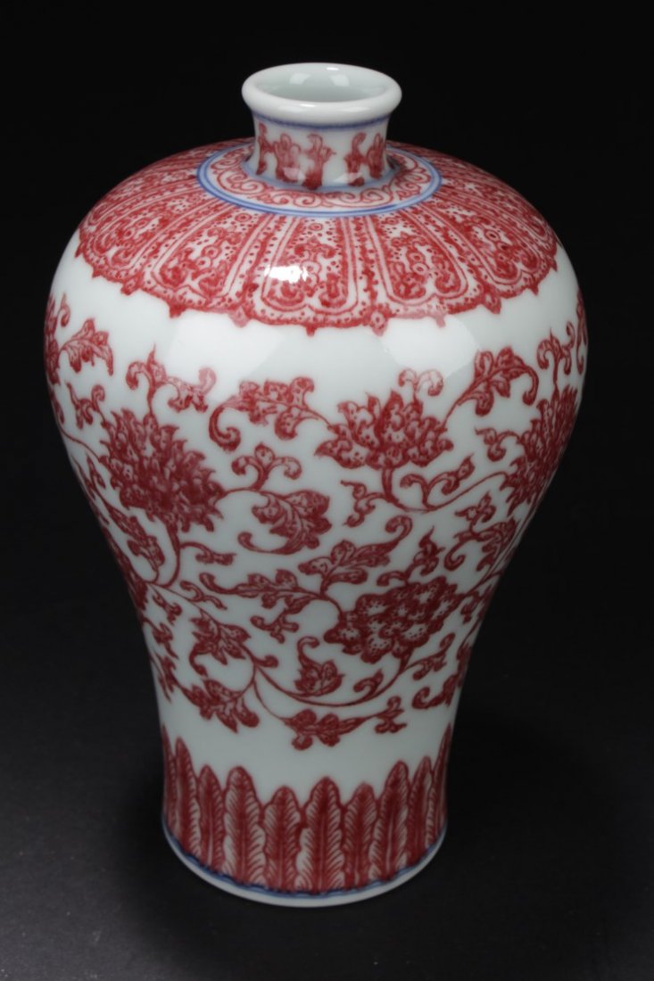 Chinese Porcelain Meiping Vase: Of broad shoulders rising to a short neck, the meiping vase is decorated with flower blossoms borne from leafy stems with its top and bottom decorated with lappet bands. 'QianLong' mark. Height: 6.75 
