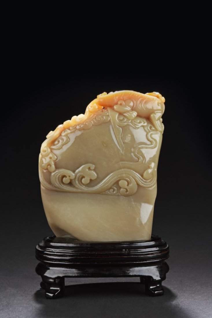 Chinese Soapstone Ornament: Chinese Soapstone Ornament, depicting a carved beast sticking out its long tongue. Comes fitted with a wooden stand. Height": 4.75 " Width: 0.75 " Length: 2.75 "