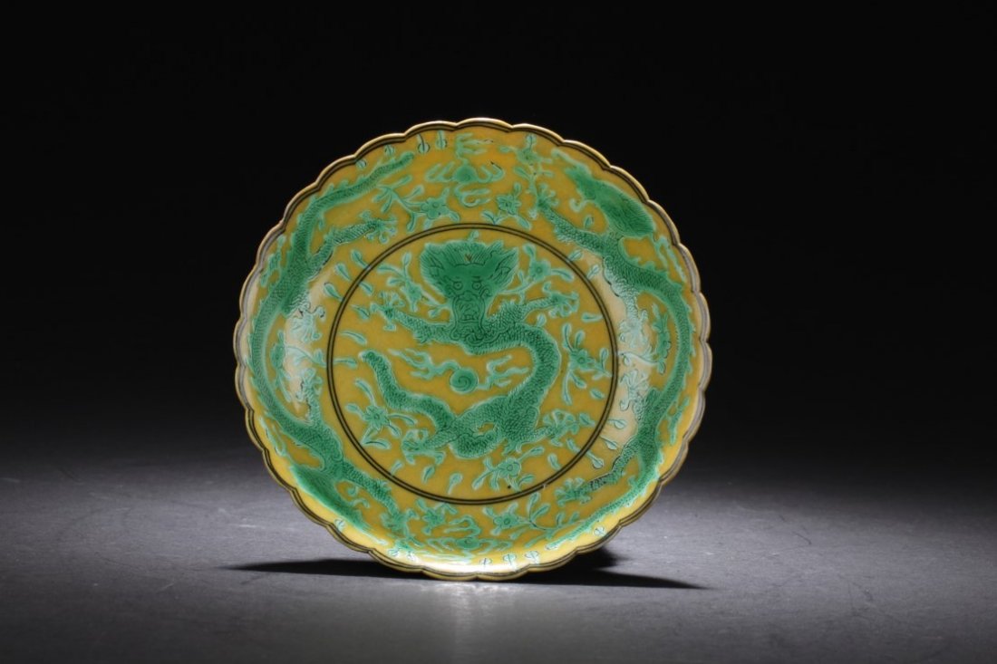 Chinese Famille Verte Porcelain Dish: Supported by a foot ring, the plate is decorated with five-claw dragons and scrolling clouds. 'QianLong' mark at bottom. Diameter: 5.25 "