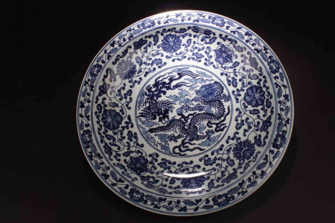Chinese Blue & White porcelain Plate: Chinese Blue & White porcelain Plate, depicting cobalt blue dragons and flower blossoms. A six character mark is imprinted at the bottom. Diameter: 16.5 "