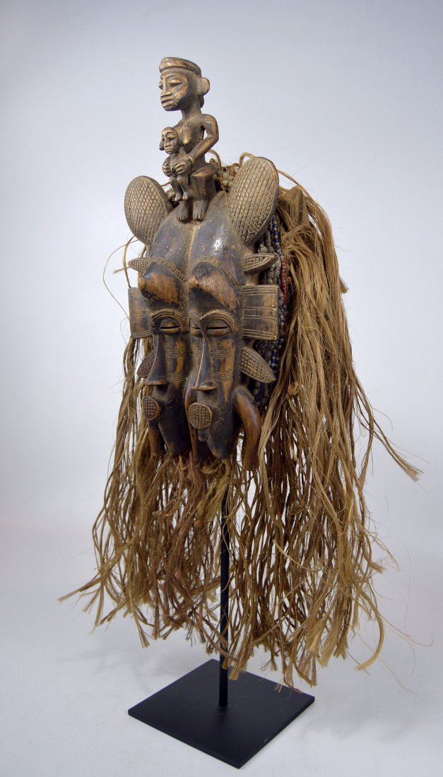 Old Senufo Janus Kpelie African Mask: Old and field used carved wooden mask from the Senufo peoples of Mali and Cote de Ivorie, West Africa. Throughout the twentieth century, members of poro, a Senufo initiation association, wore small, f