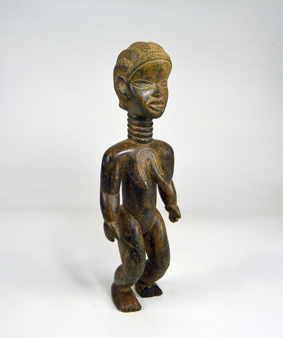 A lovely Dan female sculpture, African Art: This is a stunning vintage wood sculpture from the Dan peoples of Liberia, Africa. Featuring a female ancestor idol. Note the fantastic face and well polished surface. Measures 16 inches.