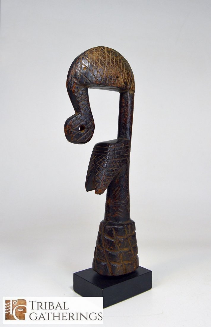 Highly Stylized Old Mossi Bigga Fertility doll: This is a wonderful Old carved wooden "Bigga" doll from the Mossi peoples of Burkina faso, West Africa. With incised designs and curled elephant style trunk , and a deep well handled surface patina. M