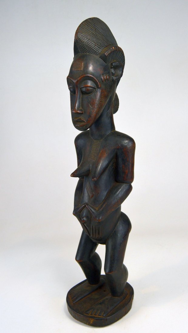 A Fine Vintage Baule Spirit Wife sculpture, African Art: Carved from a single piece of heavy dense wood, this is a vintage Baule wood sculpture of a female Spirit Wife , Or \"Blolo Bla\" from Cote De Ivorie, West Africa. This Vintage to antique idol has a v