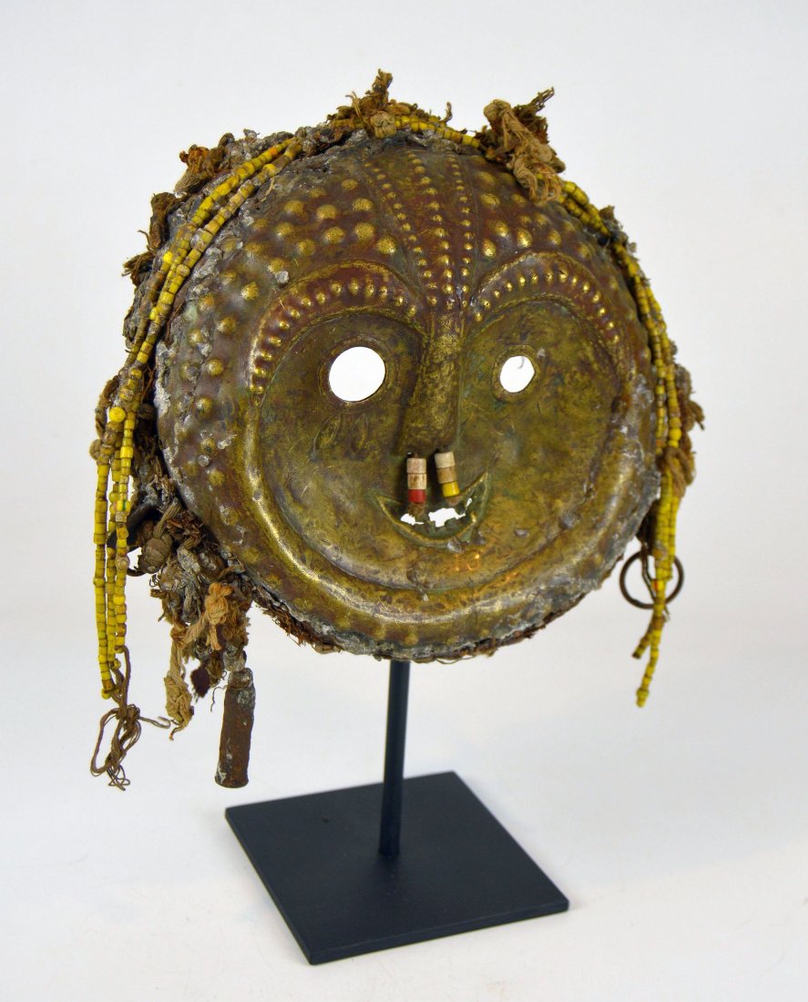 Rare Old Kwese Brass Dance Mask, African Art: This is a very rare and unusual mask from the Kwese peoples of the Congo, central Africa. Hand hammered brass mask with lavish adornment , including glass beads, textile remains and even an old bullet
