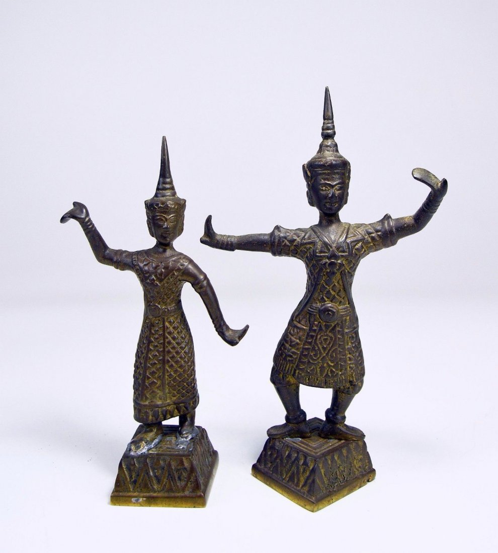 Antique Pair of Siam Dancers in bronze: This is a fine antique pair of Dancers from Siam (Modern day Thailand) with ornate dress and costume, tall finials and wonderful smiling faces.The Bronzes measures 9 inches and 8 inches tall and they 