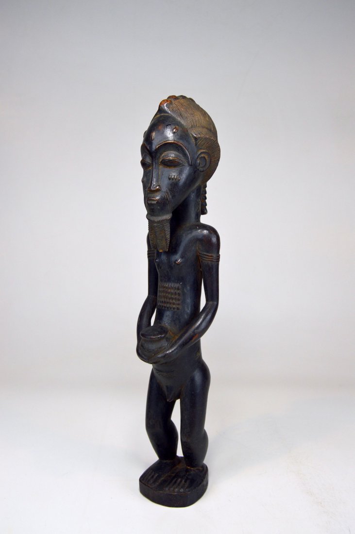 A Very Fine and handsome Baule Male Spirit Husband: An elegant and refined wood sculpture of a "Blolo Bian" Or Spirit Husband from the baule peoples of the Ivory Coast, West Africa. A handsome example with perfectly carved coifurre, braided beard and s