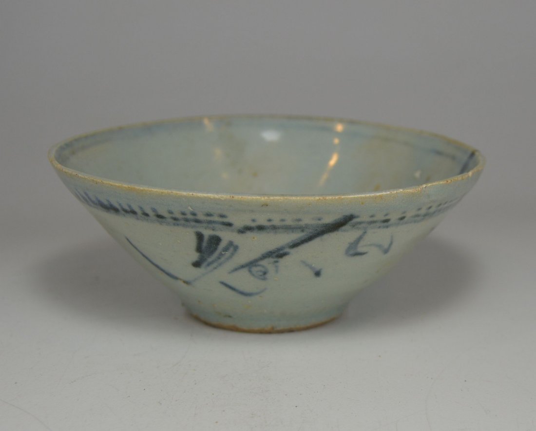 Ancient Blue & White Tea Bowl from Ming Dynasty: This is an original and ancient porcelain bowl from the Ming Dynasty of China dating back to 1368 to 1644 AD. The blue and white bowl features a simple floral motif. The Bowl measures 5 .25 inches wid