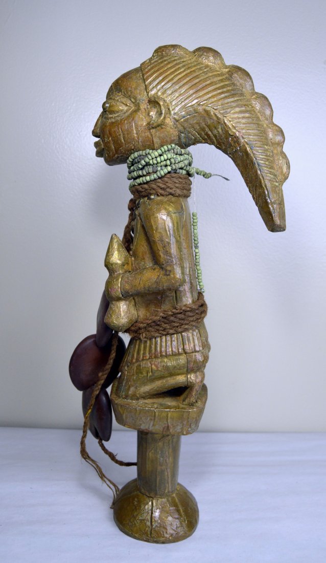 Yoruba Shango Wand African Tribal Art: Carved wooden sculpture completely covered in hand hammered brass and adorned with beads and rope, seeds and brass tacks. The Yoruba carve such staffs to carry in Yoruba "Shango" ceremonies. Measures 