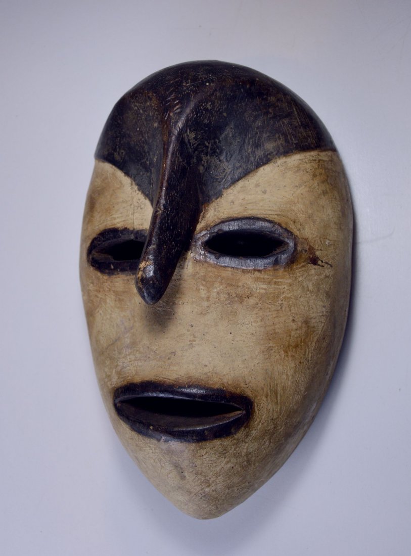Rare style of Adouma mask, African Art: carved wooden mask with heavy kaolin clay accent and unusual long nose, from the Adouma or related ethnic group, gabon, Africa, The mask measures 11 x 7 inches.