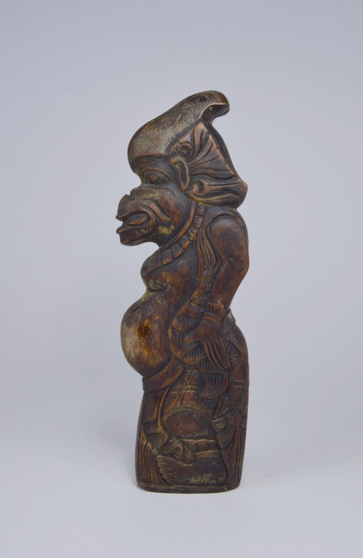 Vintage Cock Spur Container from Bali, Indonesia: This dark fruitwood case was carved in the image of a balinese deity to hold Taji or cockfighting spurs. This is a unusual container, unique in design, that is only seen in Bali, Indonesia. The Kotek 